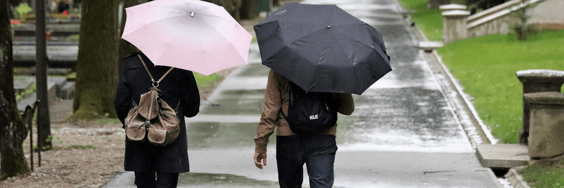Photo by Goran Horvat on Pixabay.com Two people with umbrellas walking in the rain.