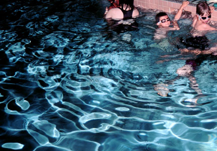 Reflections from a camera flash on the rough water of a swimming
pool.