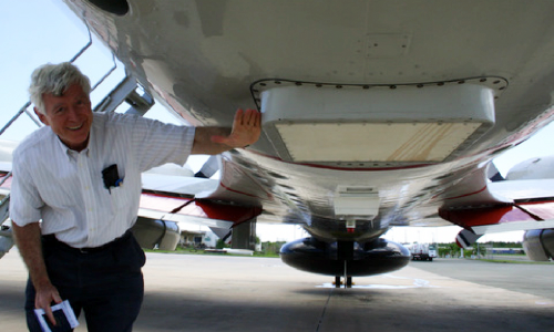 PSL researcher Ed Walsh points out the WSRA on a NOAA P-3 hurricane research aircraft. (Photo courtesy ProSensing)